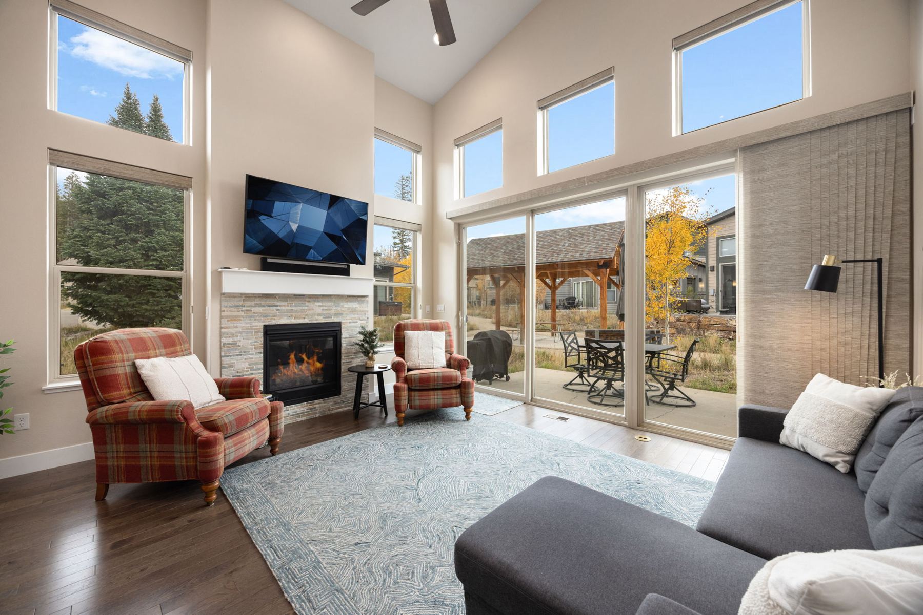 Sunlit living room with fireplace and tall windows